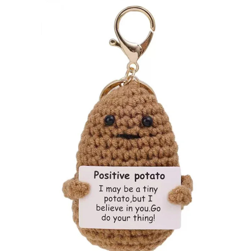 Brown Keyring design: brown crochet potato doll on a gold-tone keyring clasp, holding a small card