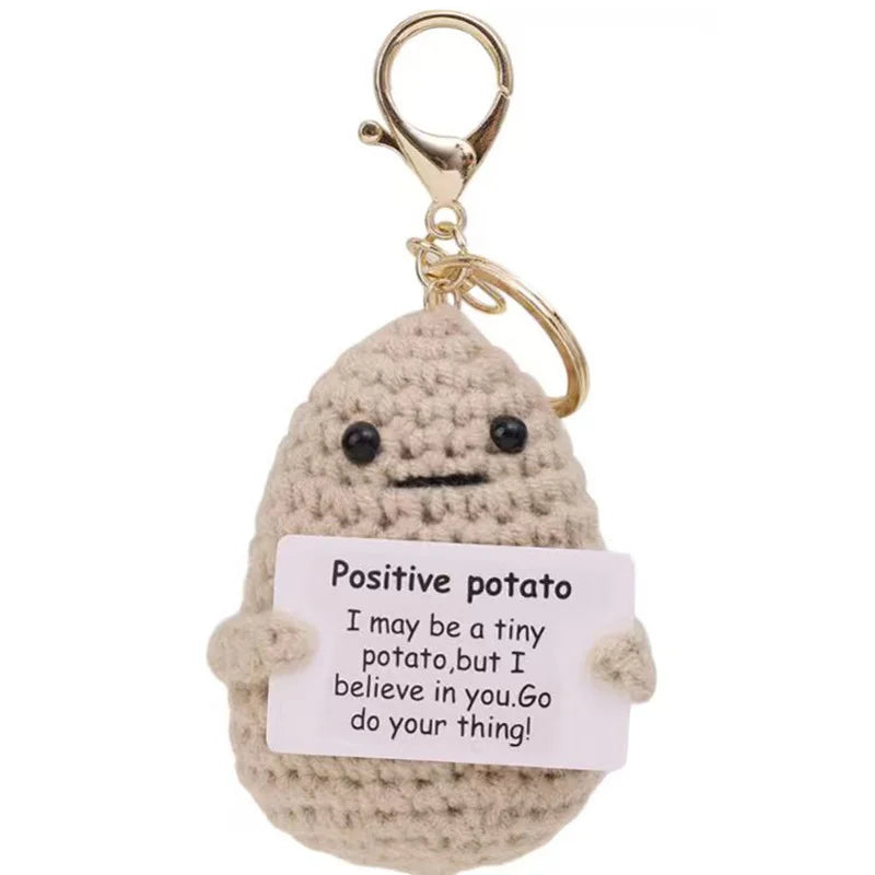 Khaki Keyring design: light khaki crochet potato doll on a gold-tone keyring clasp, holding a small card