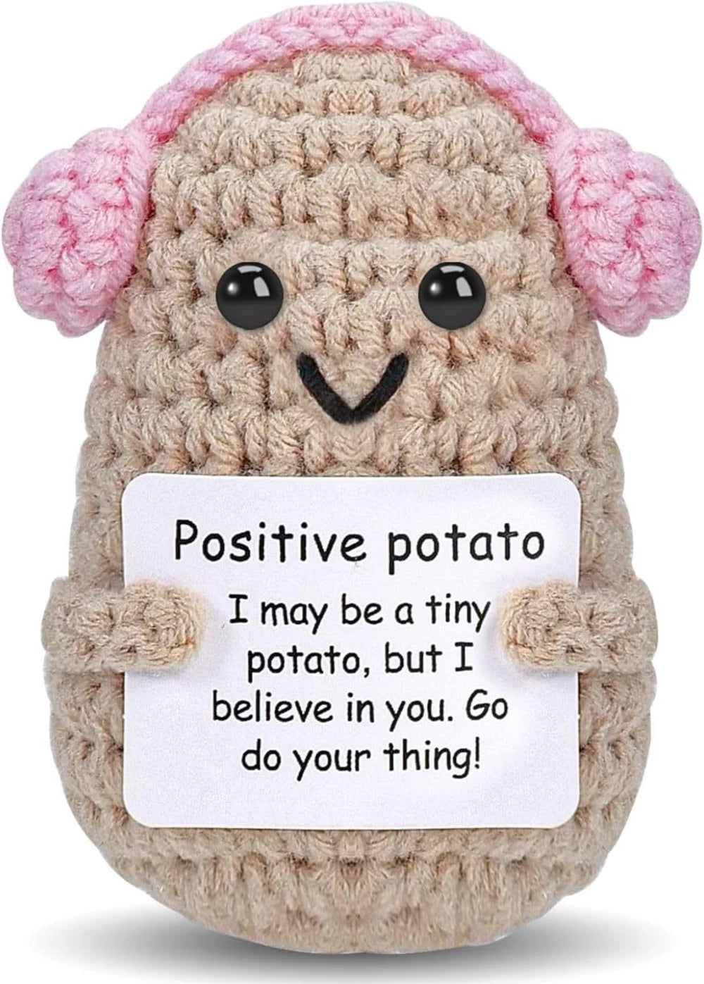 Pink Earmuffs design: khaki crochet potato doll wearing pink crochet earmuffs, holding a small card
